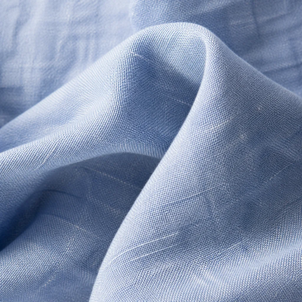 Close-up of linen shirt fabric texture showing natural slubs and weave